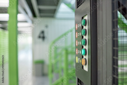 Side view of number panel with colorful buttons to call elevator connecting warehouse floors, copy space photo