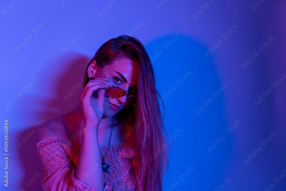 Portrait of young woman in neon light studio Portrait of young woman in neon light studio