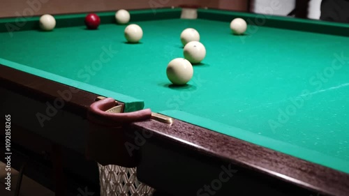 Wallpaper Mural Playing Russian billiards on a green table. The professional player hits the white ball successfully rolling its into the middle pocket. Good goal. Successful attempt. A great game. Hobby pastime. 4K Torontodigital.ca