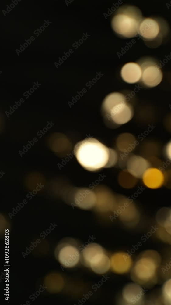 Super slow motion of glittering golden particles on black background. Shallow depth of focus. Filmed on high speed cinema camera, 1000 fps. Vertical Composition. Super slow motion of glittering golden particles on black background. Shallow depth of focus. Filmed on high speed cinema camera, 1000 fps. Vertical Composition.