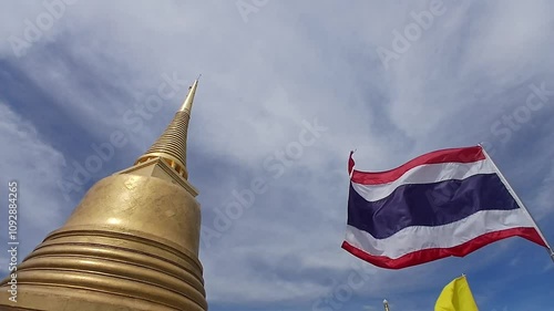 The Golden mountain temple in Bangkok with Thai National flag in windy, VDO in daytime