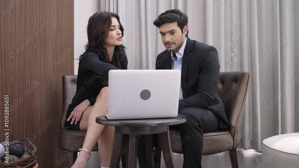 Businessman and woman working with laptop discussing project at the hotel lobby, business consultant, work presenting Businessman and woman working with laptop discussing project at the hotel lobby, business consultant, work presenting