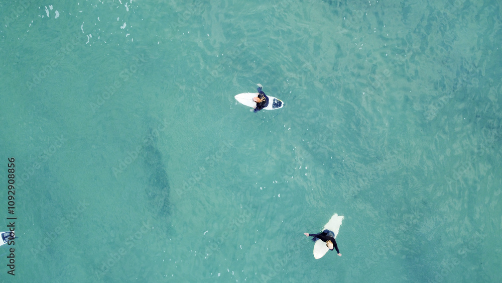 Fototapeta premium Surfers on their boards are waiting for their next wave