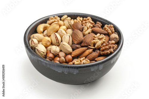 A dark bowl filled with a mix of various nuts, including almonds, walnuts, pistachios, cashews, and hazelnuts.