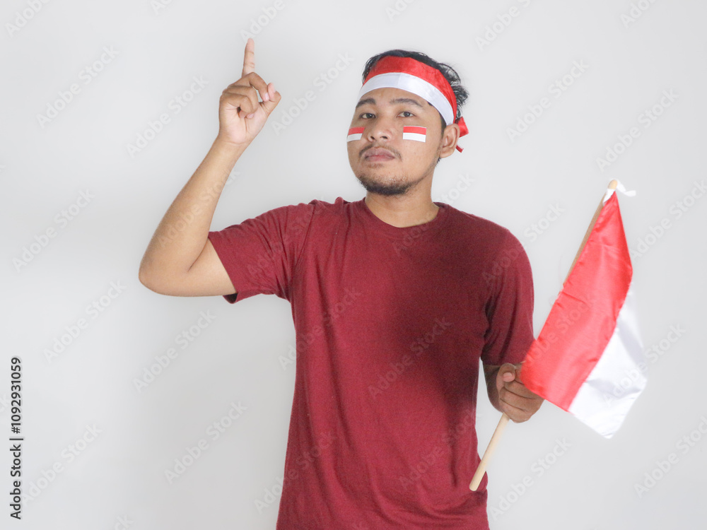 Excited young Asian men celebrate Indonesian independence day on 17 August by holding the Indonesian flag isolated over white background Excited young Asian men celebrate Indonesian independence day on 17 August by holding the Indonesian flag isolated over white background