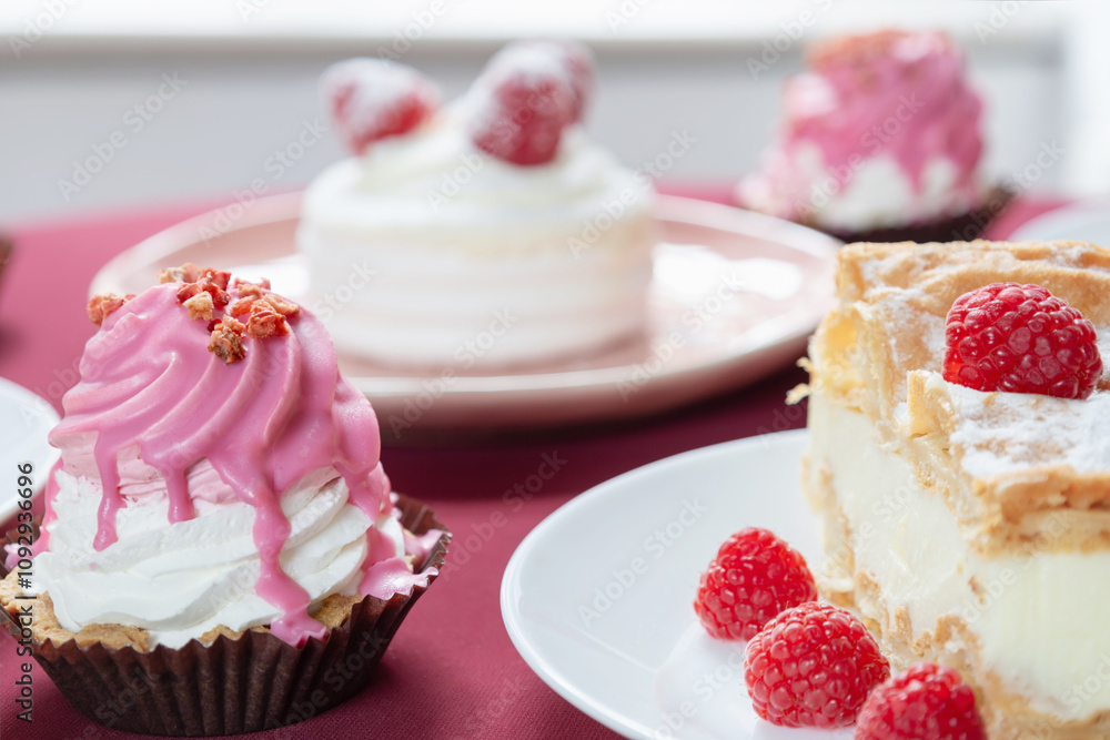 desserts with raspberries on white plates on the table desserts with raspberries on white plates on the table