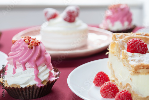 desserts with raspberries on white plates on the table