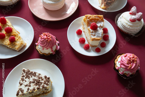 desserts with raspberries on white plates on the table