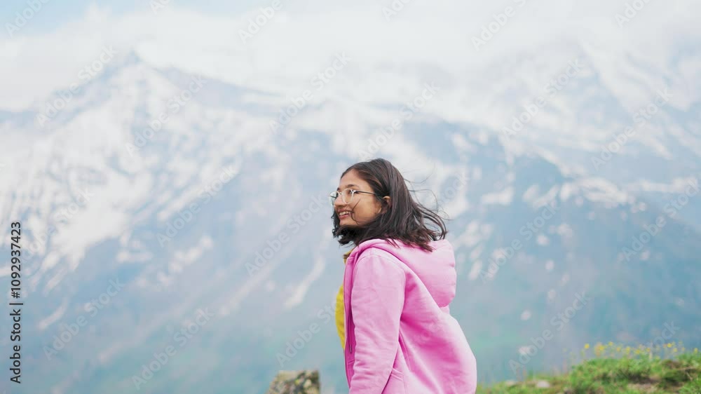 4K shot of Indian girl in mountains during winter season. Girl hiking on snowy peak and having thrilling trekking experience. Holidays and travel background. 4K shot of Indian girl in mountains during winter season. Girl hiking on snowy peak and having thrilling trekking experience. Holidays and travel background.