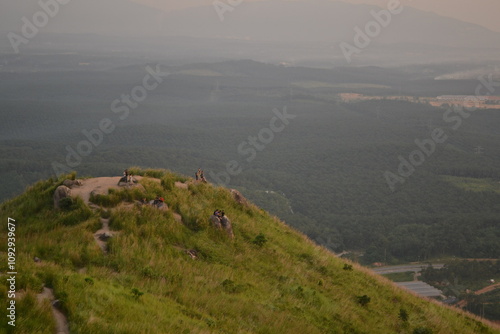 On top of the green grass hill