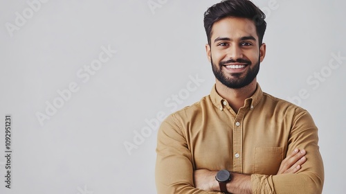 charismatic indian handsome young businessman in smart casual attire confident pose with folded hands against clean white backdrop warm smile conveys approachability and professionalism modern corpora photo