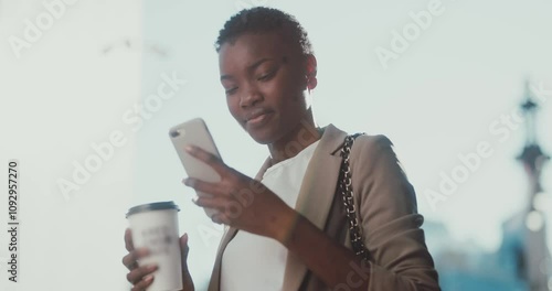 Cute young african american woman stands in a business district with coffee uses phone at sunlight. Portrait, communication, lifestyle, street, message, beautiful, businesswoman. Slow motion