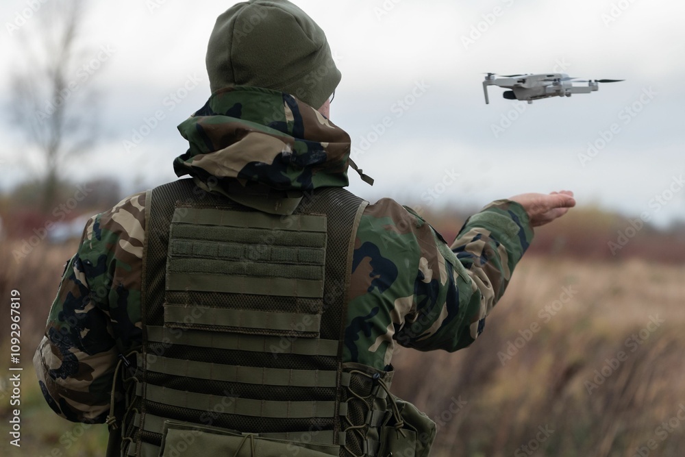 Soldier launching drone in field Soldier launching drone in field