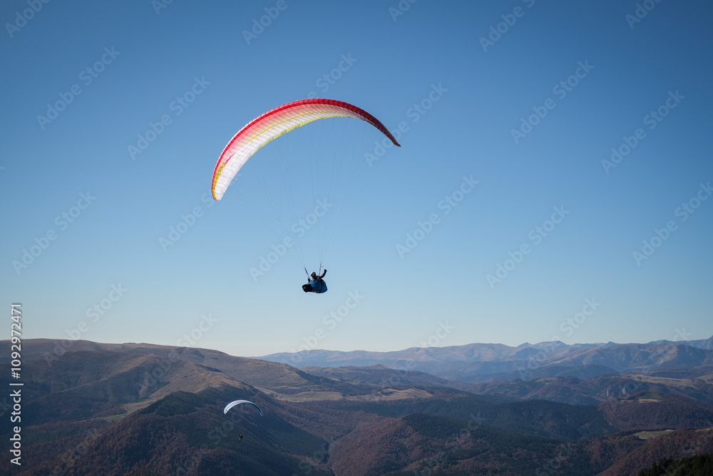 Paragliding in Ciucas mountains, Romania, during autumn season Paragliding in Ciucas mountains, Romania, during autumn season