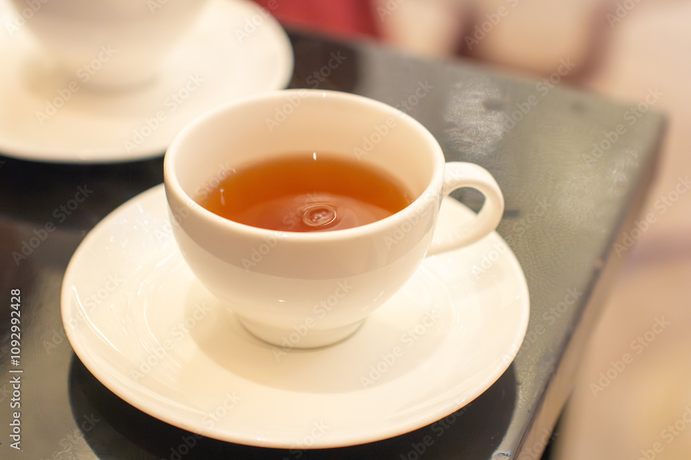 a cup of tea with a saucer that says tea on it. a cup of tea with a saucer that says tea on it.
