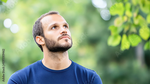 Contemplative man gazing upward park portrait natural setting close-up reflection