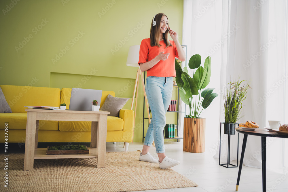 Full body photo of nice young girl walking call center operator wear orange clothes enjoy modern bright cozy spring interior flat indoors Full body photo of nice young girl walking call center operator wear orange clothes enjoy modern bright cozy spring interior flat indoors