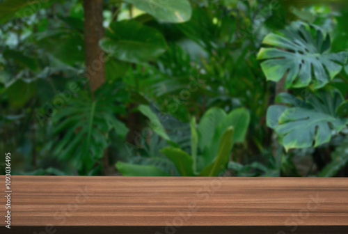 Wood table top podium floor in outdoors tropical garden forest blurred green leaf plant nature background.Natural product placement pedestal stand display,jungle paradise concept. photo