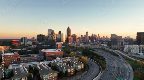 Drone footage of highways and buildings in Atlanta near Atlantic Station shot in 4k. Sideways pan of skyline in Atlanta at sunset. Close up shot o the buildings with sun reflection on buildings. 
