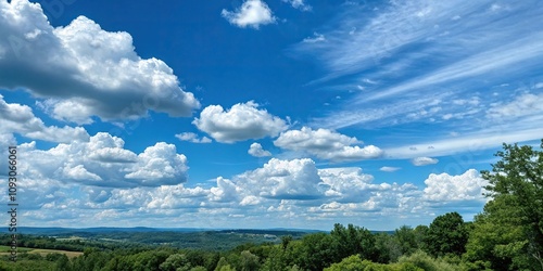 A vibrant blue sky with cumulus clouds and a hint of greenery in the distance, spring, landscape