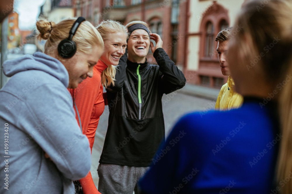 Young people getting ready to go jogging in the city together Young people getting ready to go jogging in the city together