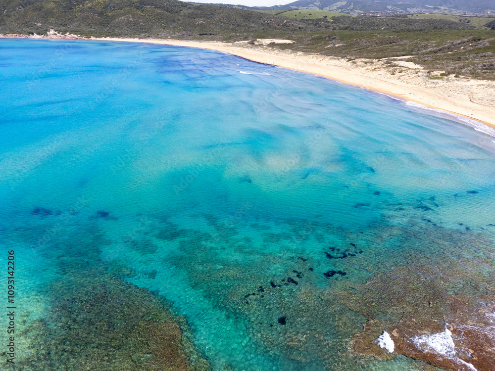 Obraz premium Aerial view of a sandy beach with turquoise water in Sardinia
