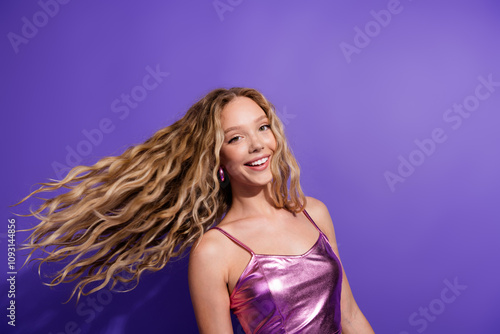 Tableau sur toile Joyful young woman with blond hair in trendy top against a vibrant purple backdr