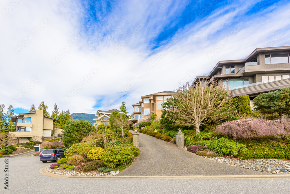 Neighbourhood of luxury houses in summer with street road, big trees and nice landscape in Vancouver, Canada. Blue sky. Day time on August 2024. Neighbourhood of luxury houses in summer with street road, big trees and nice landscape in Vancouver, Canada. Blue sky. Day time on August 2024.