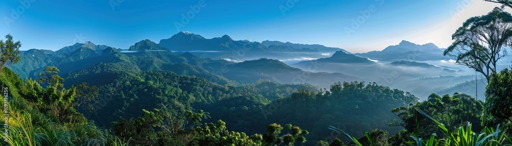 Naklejka premium Scenic mountain landscape with a clear blue sky and lush greenery Nature