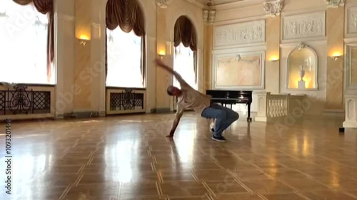 A guy does an acrobatic trick in a slow-motion theater