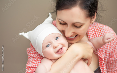 Happy mother holding a baby in her arms.
