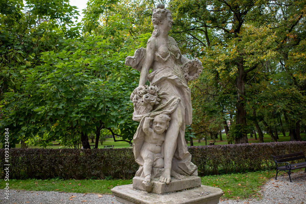 Statue of Flora (goddess of flowers and spring) with putti in park. Będzin, Poland. Statue of Flora (goddess of flowers and spring) with putti in park. Będzin, Poland.