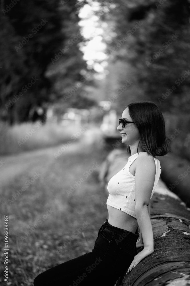 Portrait of a young beautiful dark-haired girl in the park. Black and white photo. Portrait of a young beautiful dark-haired girl in the park. Black and white photo.
