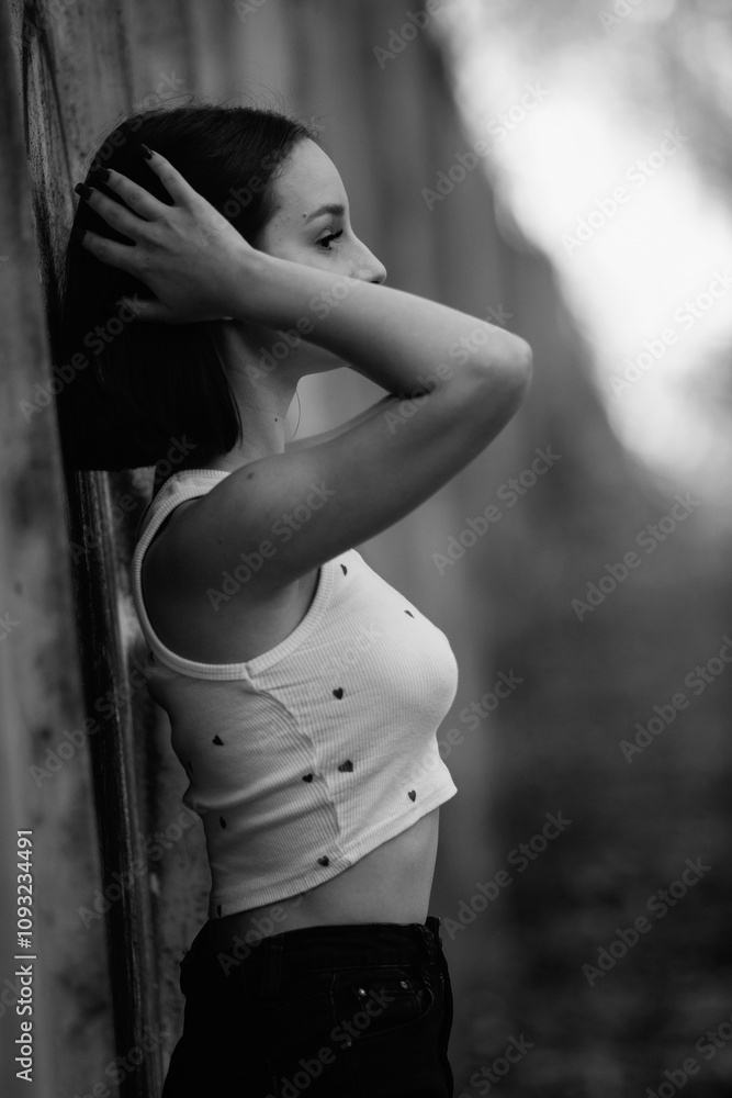 Portrait of a young beautiful dark-haired girl in the park. Black and white photo. Portrait of a young beautiful dark-haired girl in the park. Black and white photo.