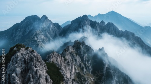 Majestic Mountain Landscape with Misty Peaks and Lush Greenery Under Clear Blue Sky Capturing Nature's Serene Beauty and Tranquility in a Scenic View