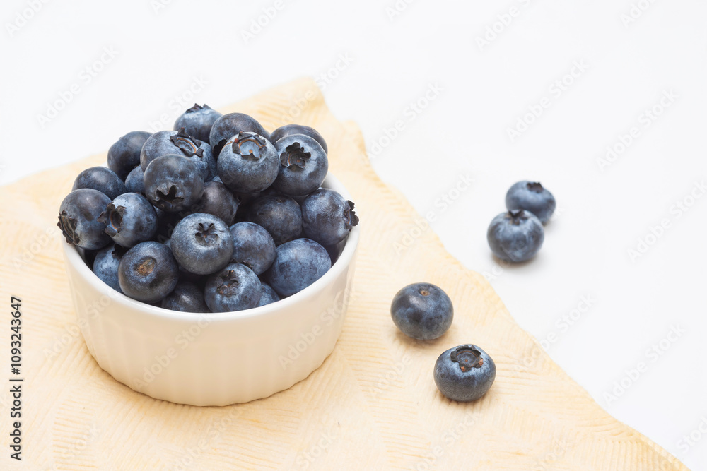 Fresh blueberries in a bowl on a light background. Harvesting Fresh blueberries in a bowl on a light background. Harvesting