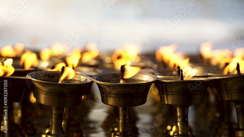 burning earthen Lamp in buddhist stupa.  photo