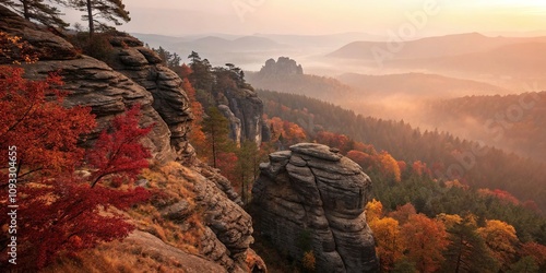 Softly glowing embers of golden light illuminate the rugged contours of a rocky gulch shrouded in a thick veil of misty autumn air amidst a sea of deep crimson and amber hues, autumn, yellow