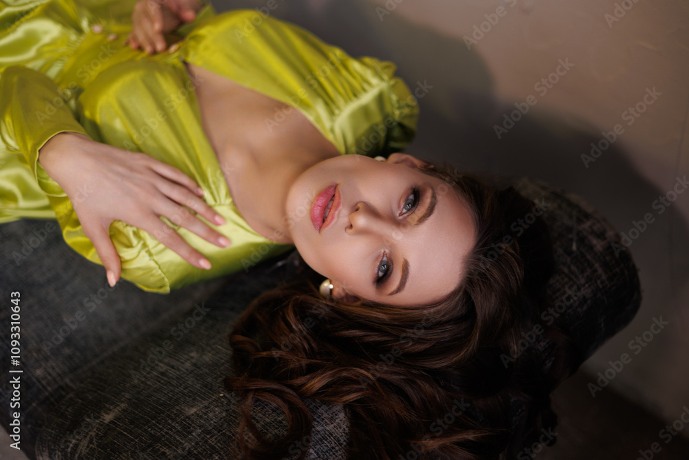 A beautiful slender tall brunette in a light green short dress. Mixed color light in the studio. A magnificent portrait of a gorgeous girl with long hair down A beautiful slender tall brunette in a light green short dress. Mixed color light in the studio. A magnificent portrait of a gorgeous girl with long hair down