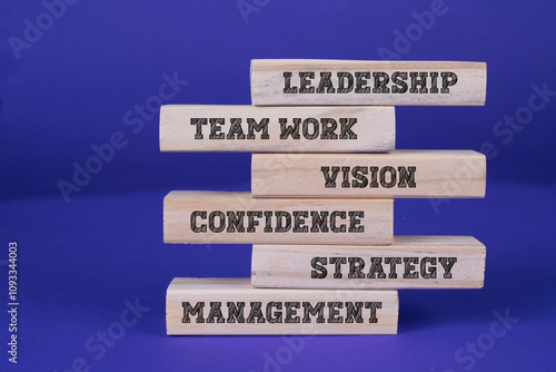 Leadership Team work vision confidence strategy management written on wooden blocks with blue background. Leadership concept, business concept