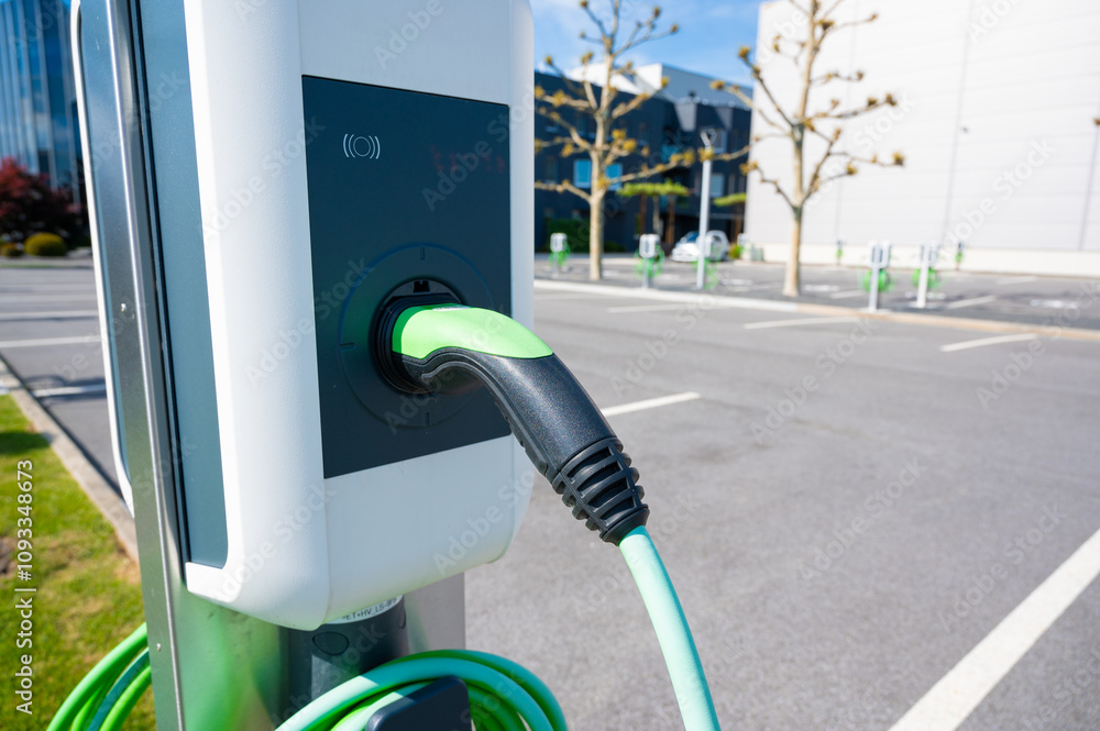 Electric car charging station. Parking lot near a modern enterprise.