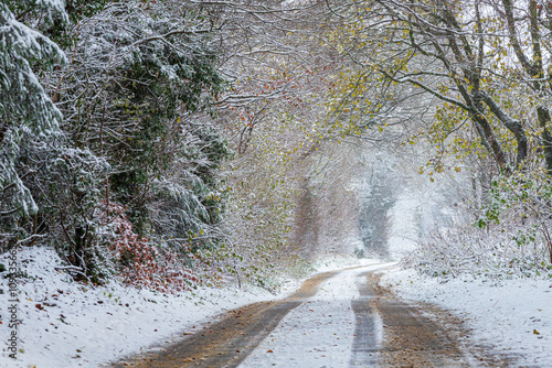 Early winter snow in November on a country lane near the Cotswold village of Taddington, Gloucestershire, England UK