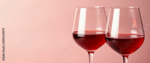 Elegant Red Wine Glasses on Soft Pink Background, romantic dinner concept, celebration, invitation, greeting card, banner with copy space	
