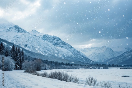 Winter scene with snow-covered mountains and falling snowflakes, cold weather, frozen terrain