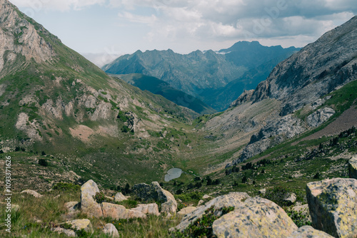 A breathtaking view of lush green hills unfolds, capturing the serenity of the French Pyrenees