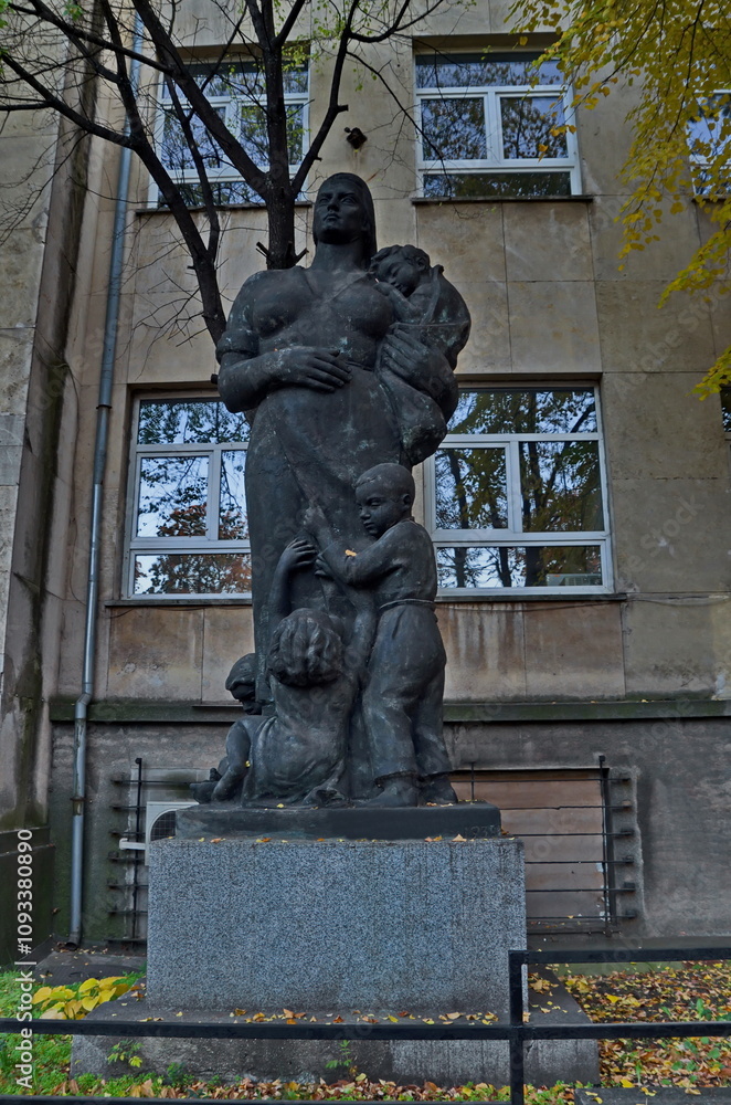Naklejka premium Exterior view of a fragment of an ancient infectious disease hospital with a sculpture of a mother with many children, Sofia, Bulgaria 