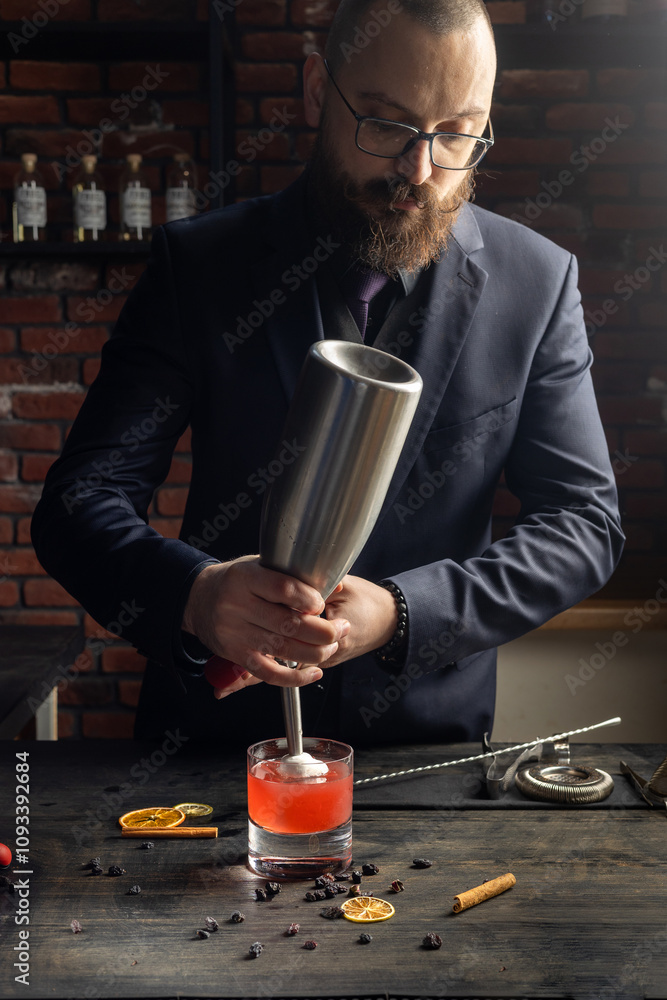 The process of preparing an alcoholic cocktail by a bartender. Winter and New Year cocktails. Bar, nightlife. Red drink. The process of preparing an alcoholic cocktail by a bartender. Winter and New Year cocktails. Bar, nightlife. Red drink.