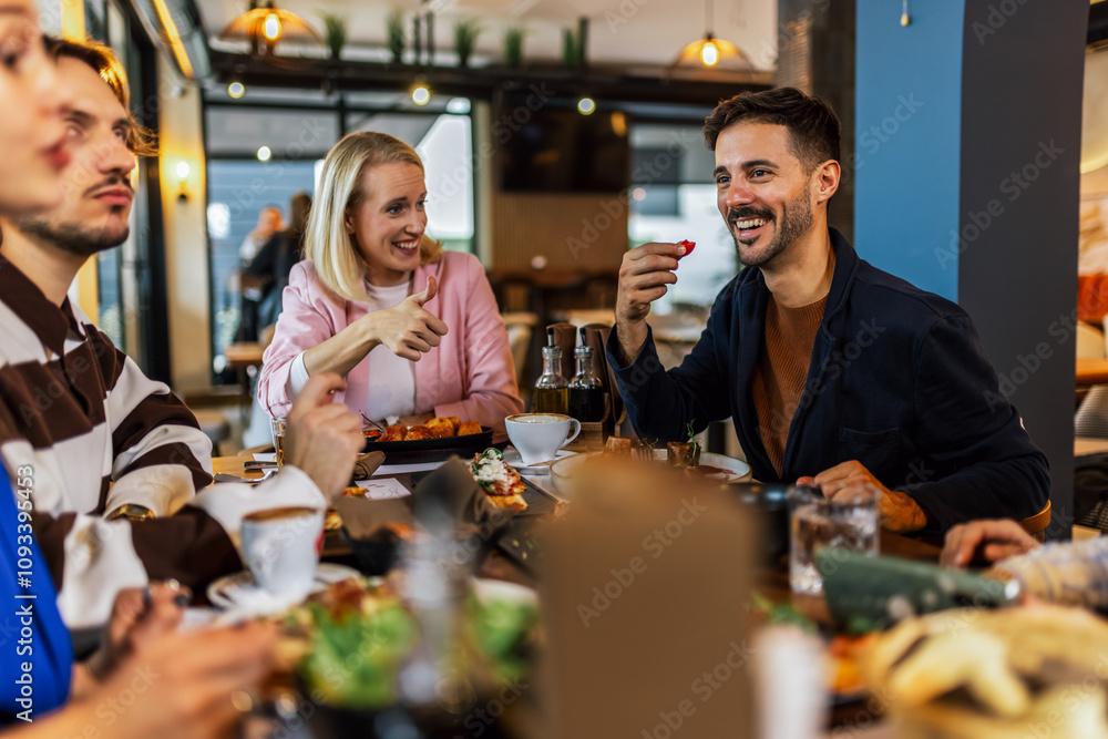Family and friends gathered in a restaurant to eat delicious food, talk, drink and hang out. Family and friends gathered in a restaurant to eat delicious food, talk, drink and hang out.