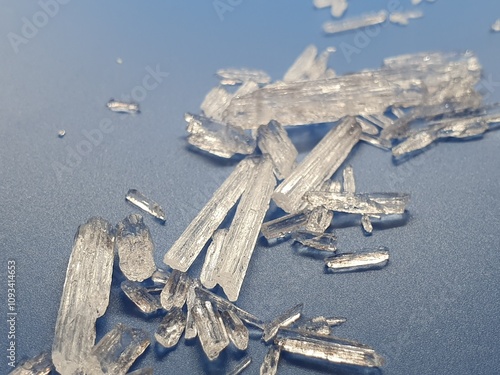 Menthol-crystals with light blue and silver background reflecting in light, looking like frozen ice crystals 