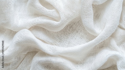 Close-up of soft, textured white fabric with gentle folds, creating a serene and delicate atmosphere.